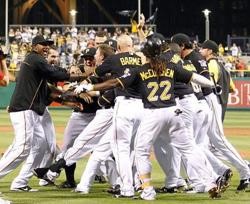 Drew Sutton gets mobbed at the plate after Sutton's ninth-inning home run lifted Pittsburgh to an 8-7 victory over the Houston Astros on Tuesday night